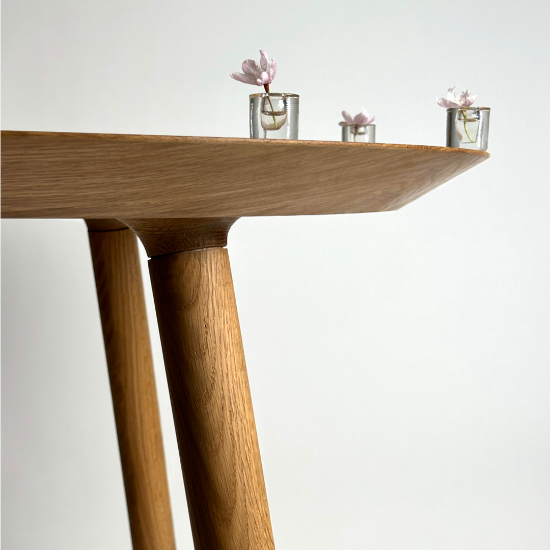 Solid wood table in white oak with cherry blossoms in tiny vases