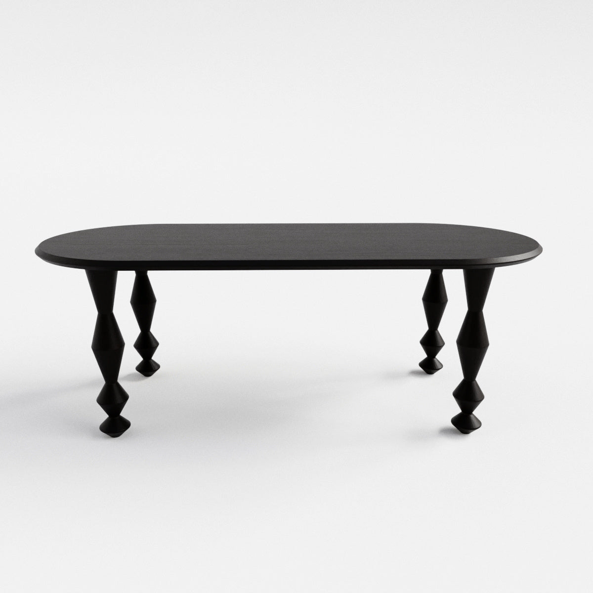 Blackened oak dining table with sculpturally shaped legs